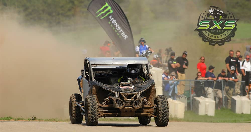 SXS racing at the 2018 Spring National in Shawano Wisconsin with a Monster Energy banner in the background and the SXS Sports logo